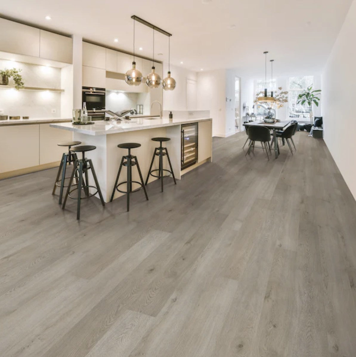 Modern kitchen with wooden flooring and white cabinetry. BiYork Angelic luxury vinyl plank floor.