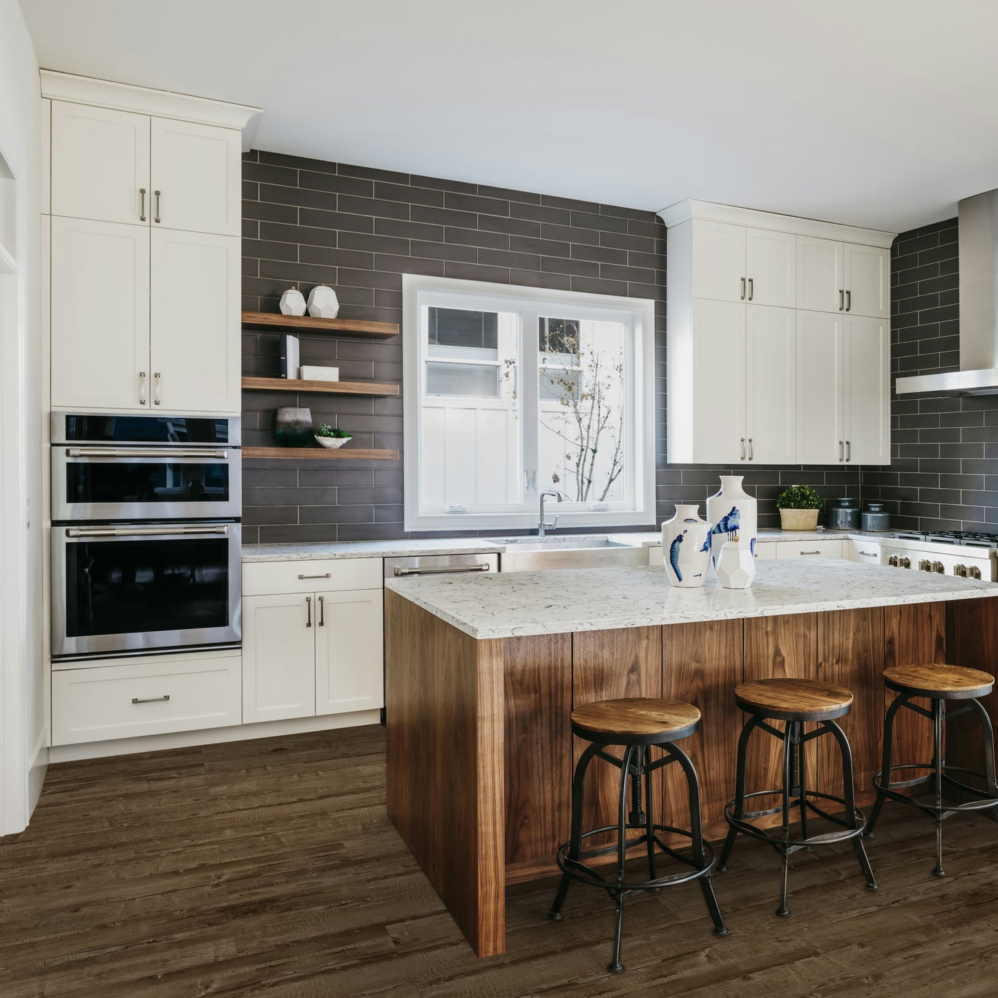 Modern kitchen with wooden island, white cabinets, and stainless steel appliances. Lakeside Park Oar laminate.