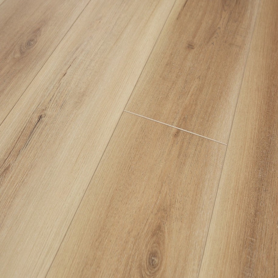 Close-up of wooden flooring with a focus on texture and grain. Coretec Originals Saffron Pecan