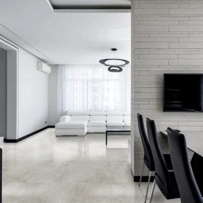Modern living room with white walls, a TV on the wall, and a dining table with chairs featuring Coastline - Capri luxury vinyl tile floor