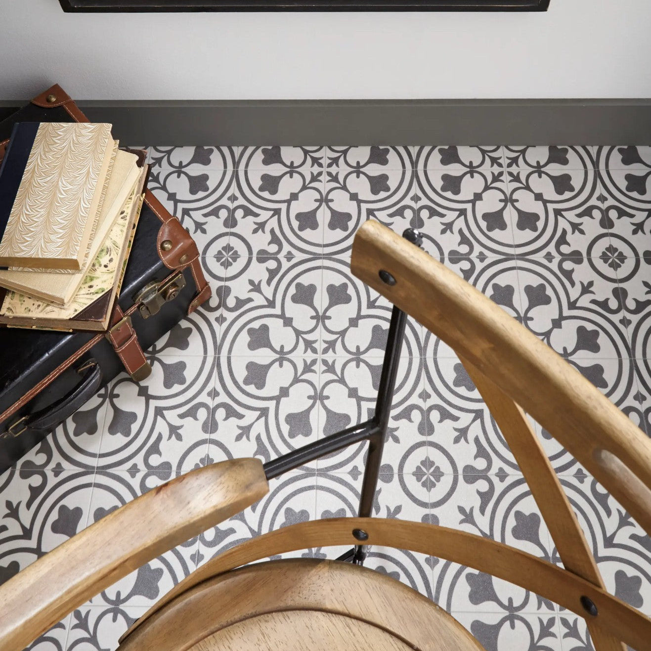 Patterned floor tile with wooden chair and suitcase. Mannington sheet vinyl Deco Wrought Iron.