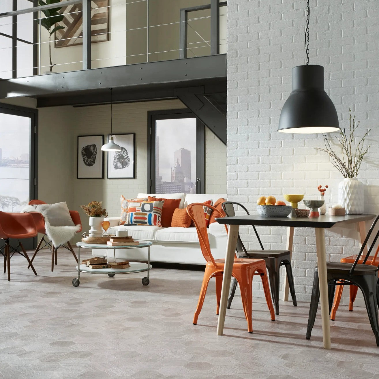 Modern living room with a white sofa, orange chairs, and a dining table. Mannington sheet vinyl Hive Pollen.