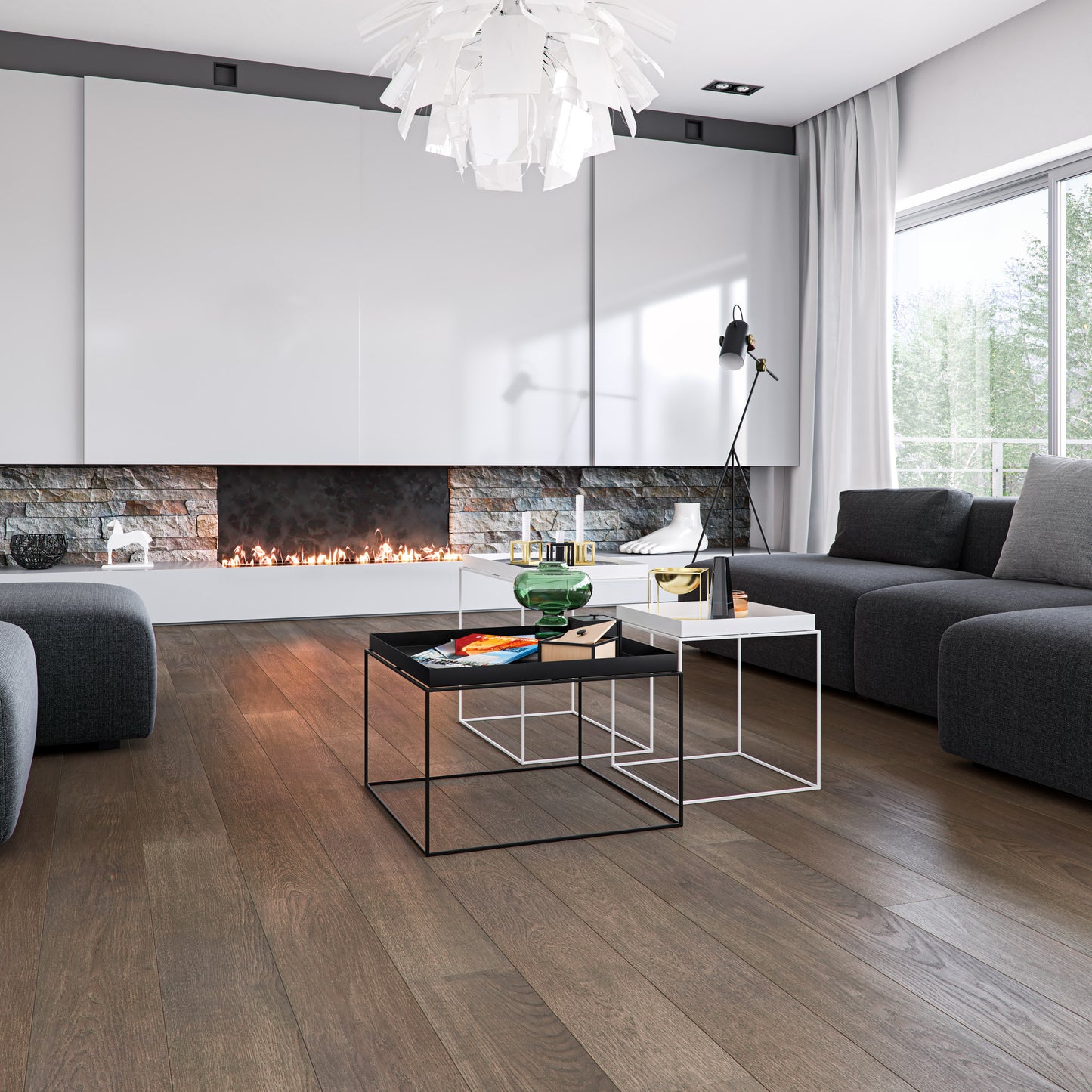 Modern living room with a fireplace, gray sofa, and glass coffee table. Millcreek Taffeta hardwood flooring.