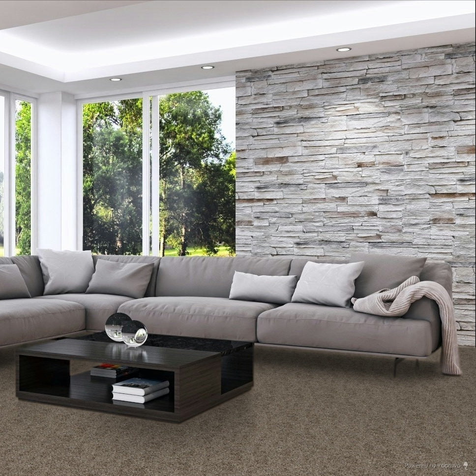 Modern living room with a large sectional sofa, coffee table, and large windows. Beaulieu Romantic Getaway Shammy carpet made in Canada.